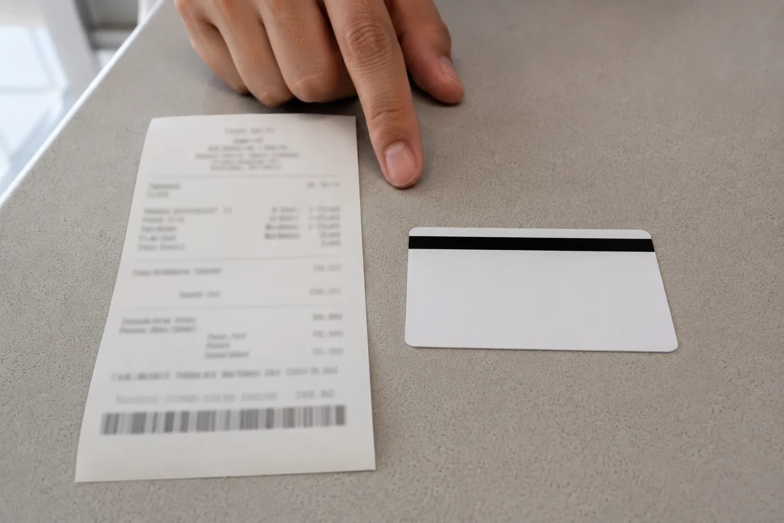 Receipt from a card-lookup return showing the refund credited to the original payment card beside a plain merchandise return card for comparison, with all sensitive details blurred.