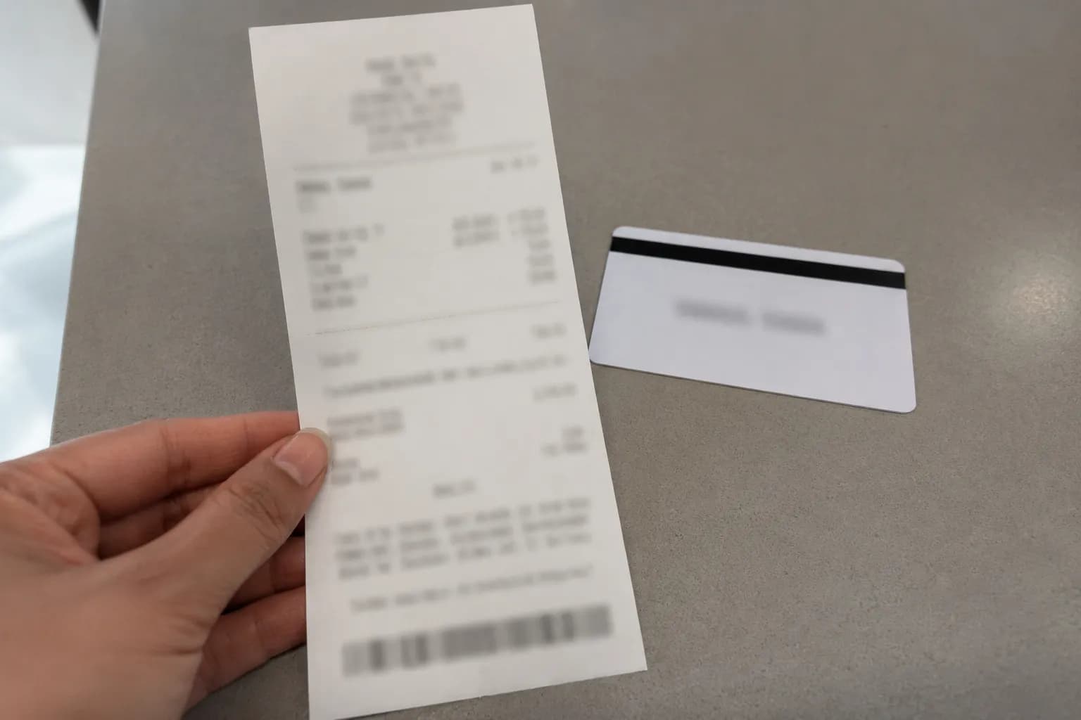 Printed return slip from a no-receipt return showing a merchandise card refund beside the store return card, with personal details and transaction information intentionally blurred.