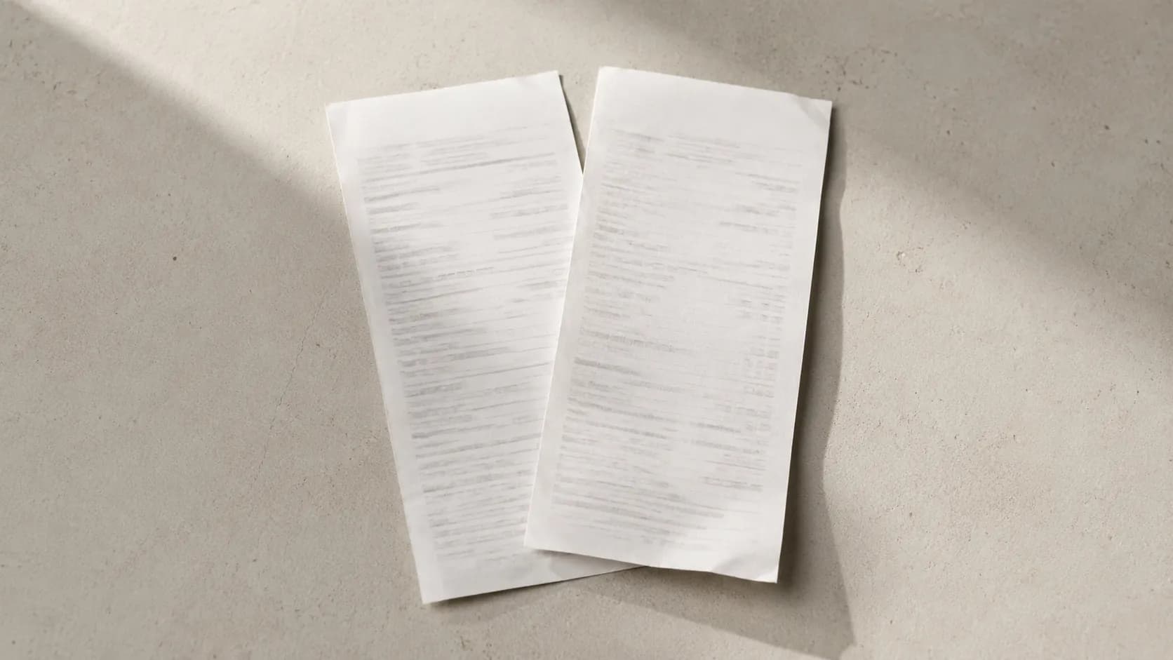 Two white receipts placed side by side on a counter representing a return transaction followed immediately by a new sale exchange.