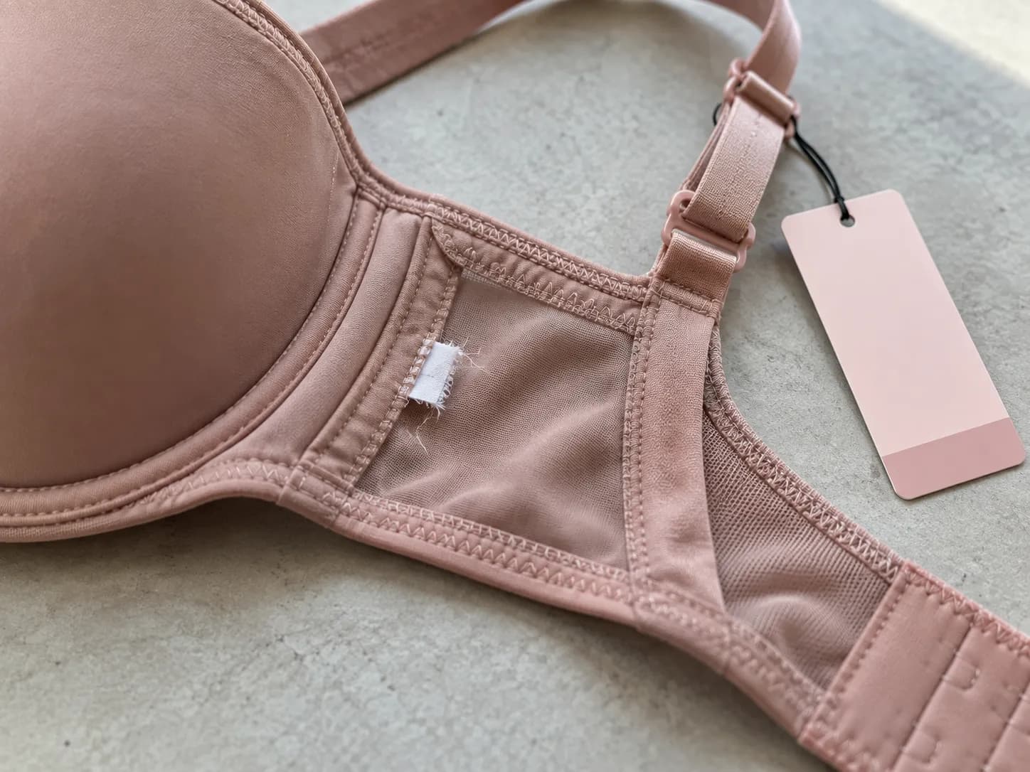 Victoria’s Secret bra refused for return because the sewn-in care and content tag was cut off, price tag still attached.