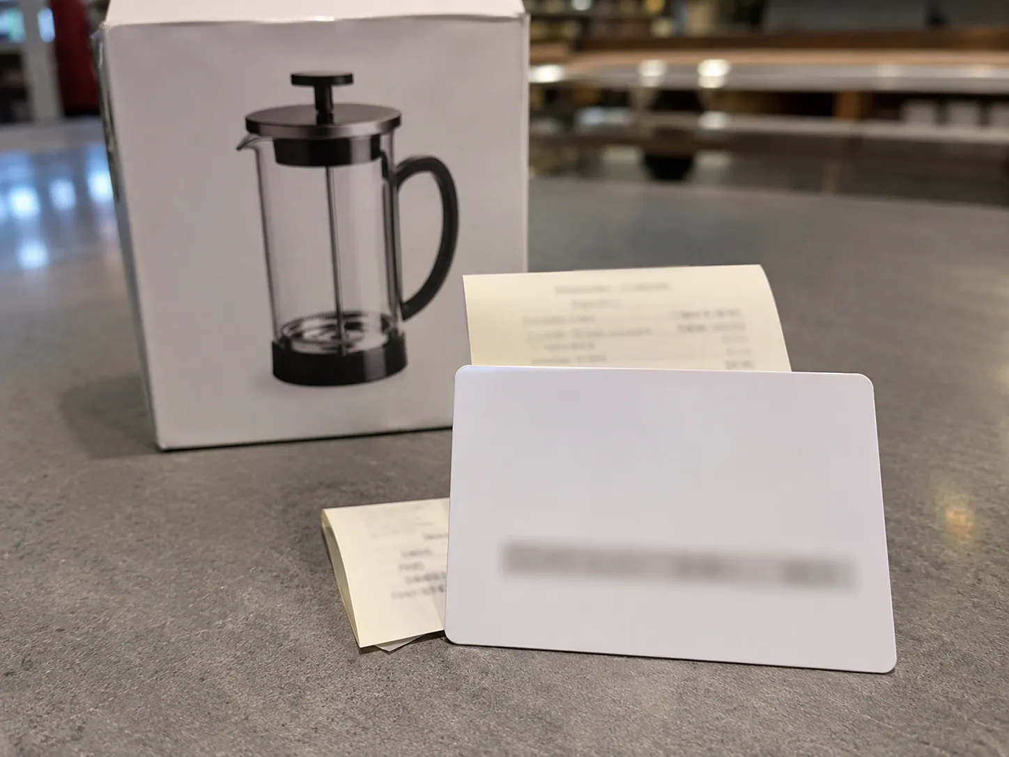 Store credit gift card issued for a Walmart no-receipt gift return, photographed beside the returned boxed kitchen item with the card number obscured for privacy.