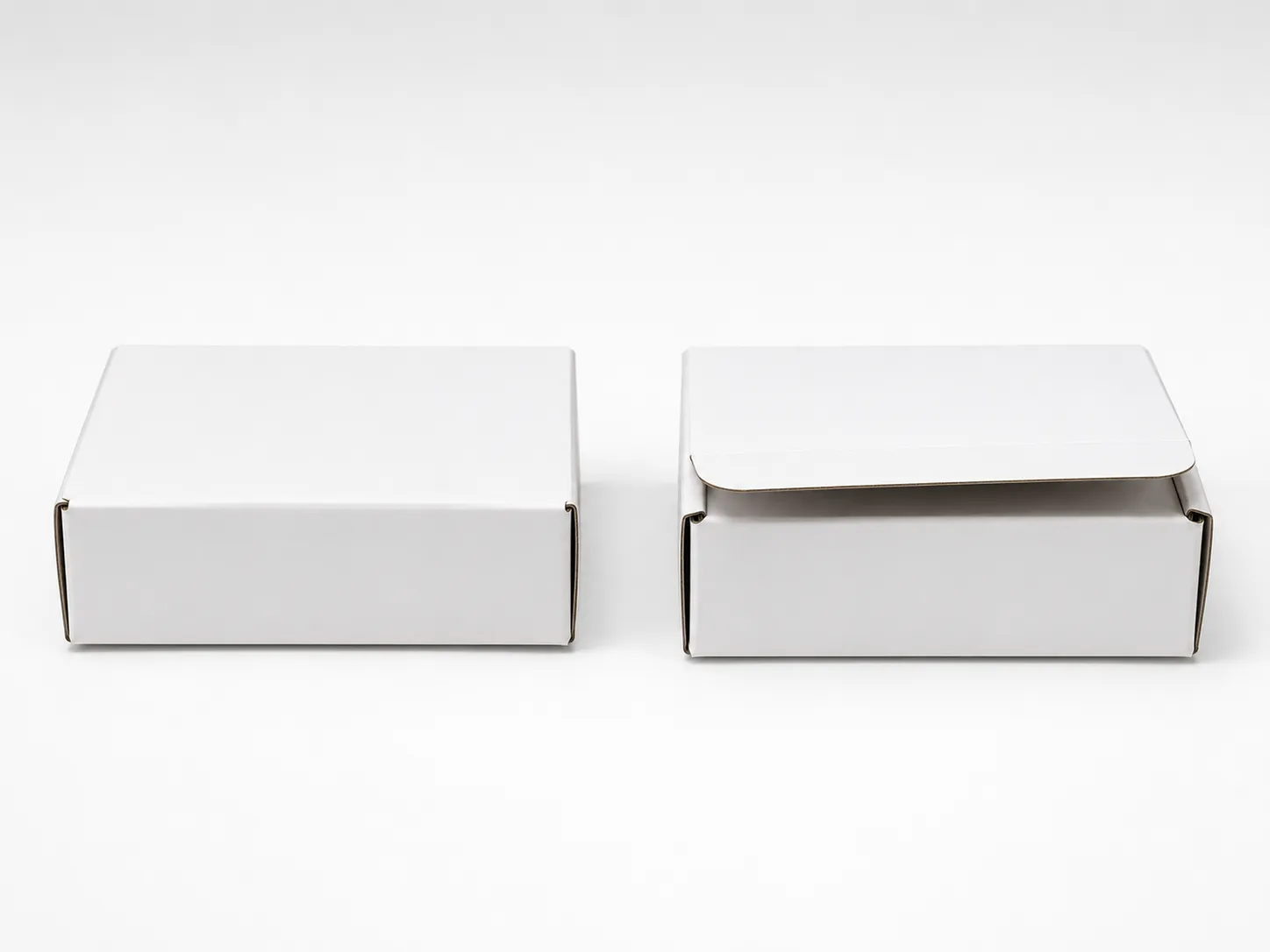 Two similar white product boxes side by side, one sealed and one slightly open, illustrating two comparable late Amazon returns with different refund outcomes.