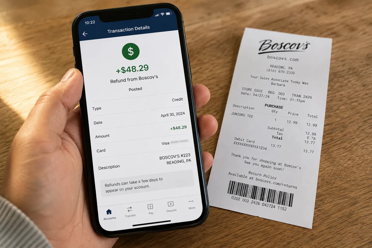 Phone showing a Boscov’s refund posted to the original card next to the paper receipt.