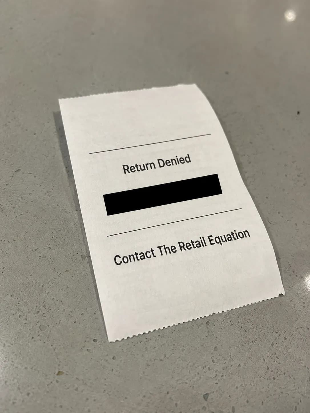 Redacted store return-denial receipt directing the shopper to contact The Retail Equation, with all personal information removed for privacy.
